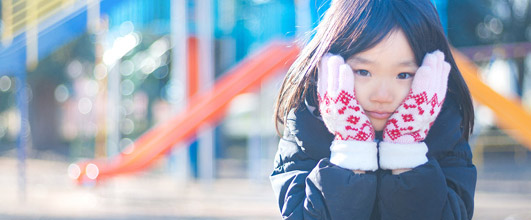 写真素材サイト「PAKUTASO」より、「寒くてほっぺをおさえる女の子」。ジユンさんの作品。モデルは、あんじゅさん。 アイキャッチ画像。