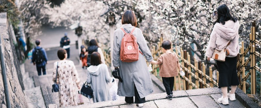 素材サイト「PAKUTASO」より、花見をする親子の後姿(湯島天神)の写真素材。カズキヒロさんの作品。梅の花です。 アイキャッチ画像。