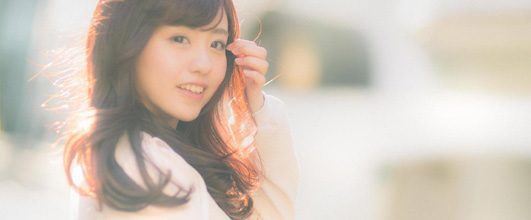 素材サイト「PAKUTASO」より、「ちょっと風強いねガール」。モデルは河村友歌さん。 アイキャッチ画像。
